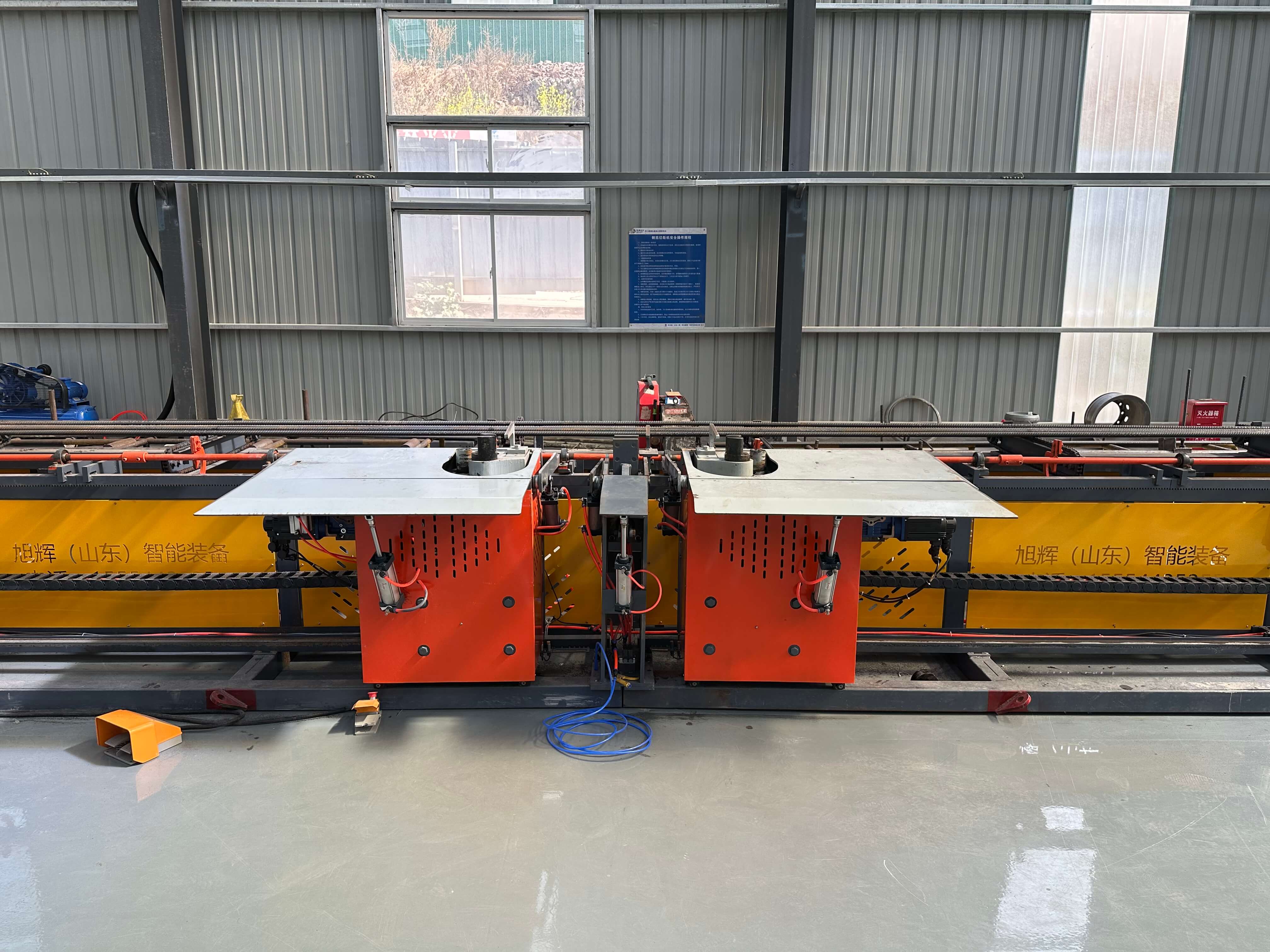 Technical team operating CNC steel bar bending equipment